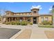 The community clubhouse features stone accents, a covered porch, colorful flowers, and accessible parking at 337 S 172Nd Dr, Goodyear, AZ 85338