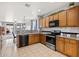 Functional kitchen featuring wooden cabinets, granite countertops, and stainless steel appliances at 337 S 172Nd Dr, Goodyear, AZ 85338