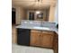 Kitchen featuring wooden cabinets, granite counters, stainless steel sink, and black dishwasher at 337 S 172Nd Dr, Goodyear, AZ 85338