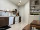 Cozy kitchen area with wood cabinets, white appliances, open shelves, and an adjacent dining nook at 337 S 172Nd Dr, Goodyear, AZ 85338