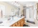 Bathroom featuring a spacious vanity, large mirror, and a shower with patterned curtains at 3546 E Latham Way, Gilbert, AZ 85297