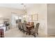 Charming dining area features a long wooden table with patterned chairs and stylish chandelier at 3546 E Latham Way, Gilbert, AZ 85297