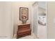 Hallway with wooden dresser, wall art, and open doorway leading to the main bedroom at 3546 E Latham Way, Gilbert, AZ 85297