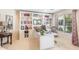 Well-lit home office with built-in bookshelves, a desk, and a window that provides natural light at 3546 E Latham Way, Gilbert, AZ 85297