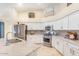 Bright kitchen with white cabinets, stainless steel appliances, and granite countertops and gray tile backsplash at 3546 E Latham Way, Gilbert, AZ 85297