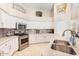 Bright kitchen with white cabinets, stainless steel appliances, granite countertops, and gray tile backsplash at 3546 E Latham Way, Gilbert, AZ 85297