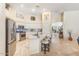 Bright kitchen with white cabinets, stainless steel appliances, granite countertops, and kitchen island with bar stool seating at 3546 E Latham Way, Gilbert, AZ 85297