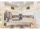 Bright kitchen featuring white cabinets, granite countertops, a center island with seating, and stainless steel appliances at 3546 E Latham Way, Gilbert, AZ 85297