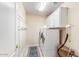 Well-lit laundry room with modern washer and dryer, storage cabinets, and hanging hooks at 3546 E Latham Way, Gilbert, AZ 85297