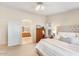 Bright main bedroom with a king bed and access to the ensuite bathroom at 3546 E Latham Way, Gilbert, AZ 85297