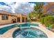 Inviting backyard pool and spa with covered patio, perfect for outdoor entertaining and relaxation on a sunny day at 3546 E Latham Way, Gilbert, AZ 85297