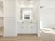 Bathroom featuring double sinks, white cabinets, and a large mirror at 3764 N Camden Dr, Florence, AZ 85132