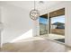 Dining room with modern chandelier and sliding glass doors leading to the backyard at 3764 N Camden Dr, Florence, AZ 85132