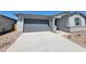 Single-story home with a gray garage door, concrete driveway, neutral stucco, and low-maintenance desert landscaping at 3764 N Camden Dr, Florence, AZ 85132