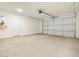 Spacious garage with an automatic door, water heater, and ample storage space at 3764 N Camden Dr, Florence, AZ 85132