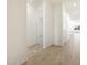 Bright hallway with wood-look tile flooring leading to bedrooms and living areas at 3764 N Camden Dr, Florence, AZ 85132