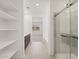 Hallway featuring modern bathroom with dual sinks, walk-in shower, and built-in shelving at 3782 N Camden Dr, Florence, AZ 85132