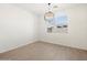 Bright dining room with neutral paint, wood-look tile flooring, and a modern globe chandelier at 3782 N Camden Dr, Florence, AZ 85132