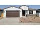 Charming single-story home featuring a two-car garage and desert landscaping in front at 3782 N Camden Dr, Florence, AZ 85132