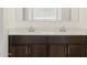 Bathroom featuring double sinks with dark cabinets and a light countertop at 3864 N Camden Dr, Florence, AZ 85132