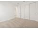 Bright bedroom featuring plush carpeting, ample closet space with sliding doors, and neutral décor for versatile styling at 3864 N Camden Dr, Florence, AZ 85132