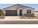 Inviting single-story home with a two-car garage, modern stucco, and low-maintenance desert landscaping for easy living at 3864 N Camden Dr, Florence, AZ 85132