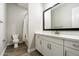 Bright bathroom with a modern vanity, large mirror, and a shower-tub combination at 4097 E Tonto Pl, Chandler, AZ 85249