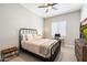 Cozy bedroom with a black iron bed frame, carpet flooring, and a modern dresser at 4097 E Tonto Pl, Chandler, AZ 85249