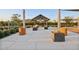 Community gathering area with a covered seating space, decorative planters, and manicured landscaping at 4097 E Tonto Pl, Chandler, AZ 85249