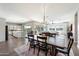 Open dining room with wood table, chandelier, and view into the kitchen and backyard at 4097 E Tonto Pl, Chandler, AZ 85249