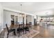 Spacious dining room with wood table, chandelier, and view into open-concept kitchen at 4097 E Tonto Pl, Chandler, AZ 85249