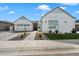 Charming exterior of a white single-story home with a two-car garage, desert landscaping, and paved walkway at 4097 E Tonto Pl, Chandler, AZ 85249