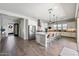 Bright kitchen featuring white cabinets, a large center island with seating, and stainless steel appliances at 4097 E Tonto Pl, Chandler, AZ 85249