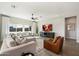 Beautiful living room with a large sectional sofa, stylish decor, and natural light streaming through the windows at 4097 E Tonto Pl, Chandler, AZ 85249