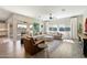 Bright and airy living room featuring a comfortable sectional, leather chair, and large sliding glass doors to the patio at 4097 E Tonto Pl, Chandler, AZ 85249