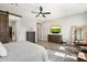 Stylish main bedroom with wood floors, ceiling fan, and a barn door entry to closet at 4097 E Tonto Pl, Chandler, AZ 85249