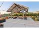 Inviting outdoor seating area with a shade structure and string lights, perfect for relaxation and social gatherings at 4097 E Tonto Pl, Chandler, AZ 85249