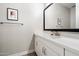 Stylish powder room featuring a modern vanity, framed mirror, and neutral wall color at 4097 E Tonto Pl, Chandler, AZ 85249