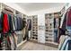 Organized walk-in closet with custom shelving, hanging rods, and ample storage space for clothes and shoes at 4097 E Tonto Pl, Chandler, AZ 85249