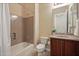 Full bathroom featuring a shower-tub combination and single vanity with wood cabinets and a cultured marble countertop at 41413 N Club Pointe Dr, Anthem, AZ 85086