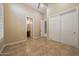 Secondary bedroom with tile flooring and a view to the bathroom, with a white sliding door closet at 41413 N Club Pointe Dr, Anthem, AZ 85086