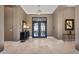 Elegant foyer with marble flooring, dark wood accents, and a view of the beautifully designed front doors at 41413 N Club Pointe Dr, Anthem, AZ 85086