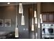 Close-up shot of the modern pendant lighting hanging above the kitchen island at 41413 N Club Pointe Dr, Anthem, AZ 85086