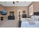 The main bedroom features neutral color, carpeted floor, television and dresser at 41413 N Club Pointe Dr, Anthem, AZ 85086