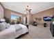 The main bedroom features neutral color, carpeted floor, television and access to a balcony at 41413 N Club Pointe Dr, Anthem, AZ 85086