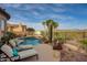 A luxurious backyard pool area with lounge chairs and desert landscaping at 41413 N Club Pointe Dr, Anthem, AZ 85086