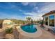 A tranquil backyard pool featuring a spa, desert landscaping, and mountain views at 41413 N Club Pointe Dr, Anthem, AZ 85086