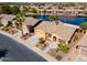 Home aerial view with well-manicured desert landscaping, concrete driveway and community lake at 42432 W North Star Dr, Maricopa, AZ 85138