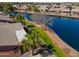 View of a house roof and backyard featuring desert plants and community lake at 42432 W North Star Dr, Maricopa, AZ 85138