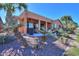 Covered back patio includes ceiling fans and stylish furniture for relaxing, nestled in a garden with desert landscaping at 42432 W North Star Dr, Maricopa, AZ 85138